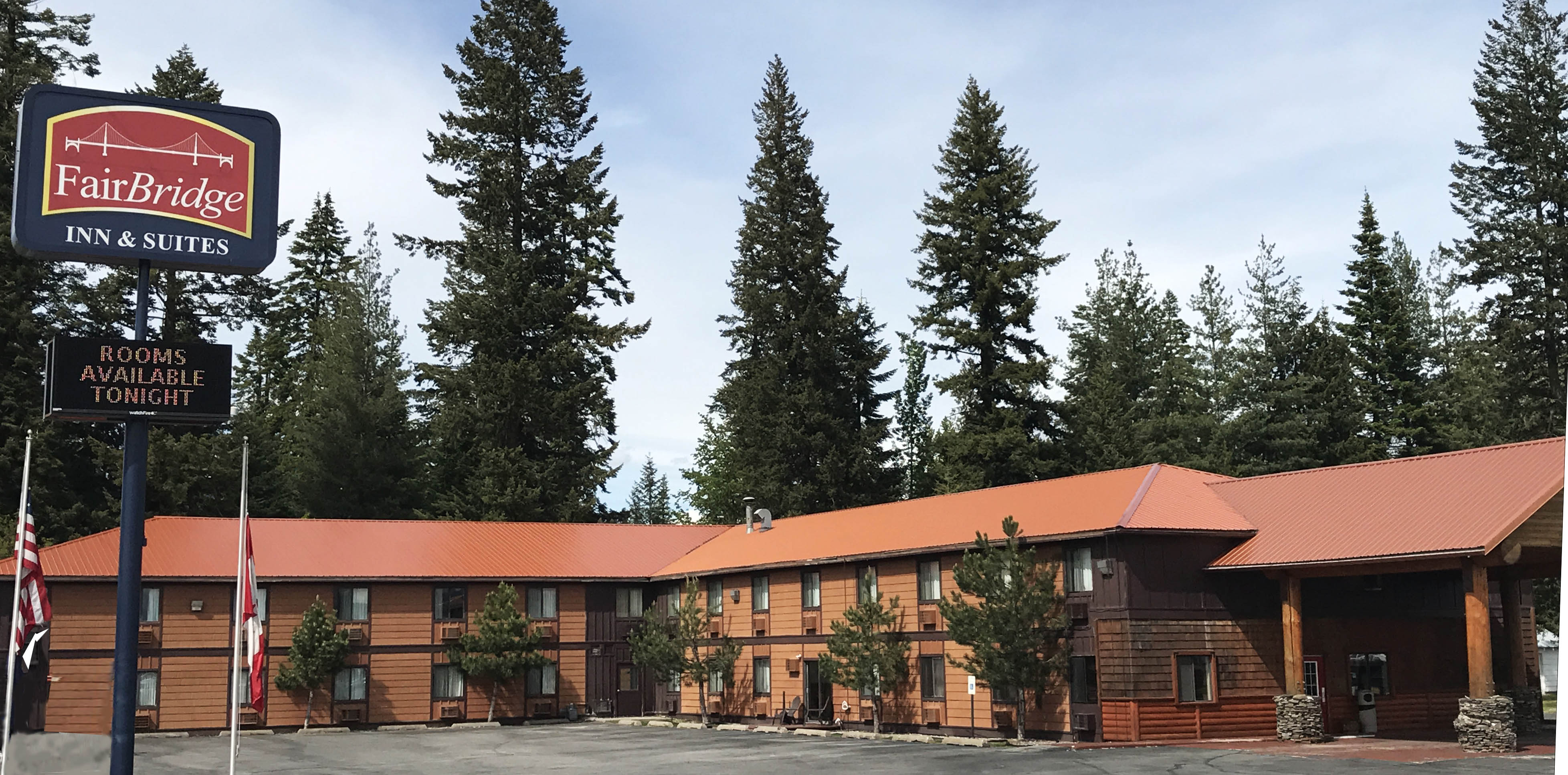Timber-built FairBridge Inn & Suites among tall pines